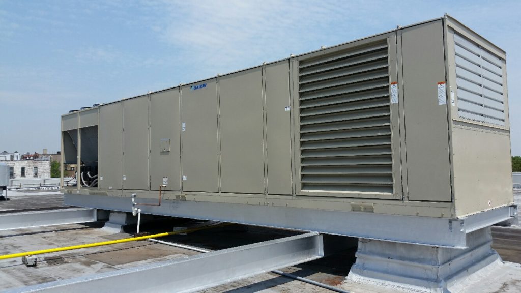 Light green HVAC system on rooftop of building