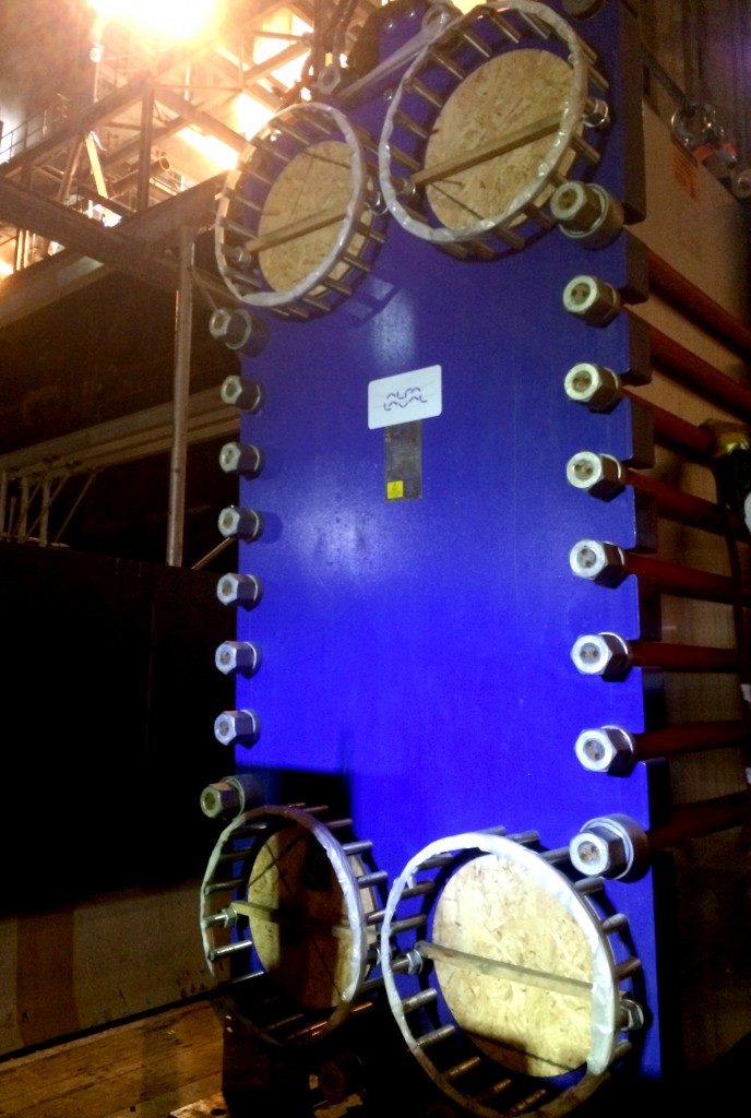 Blue cooling tower on flatbed of truck while being delivered