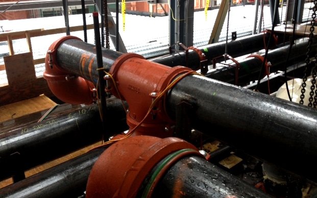 Red and black cooling pipes connected to perpendicular pipes.