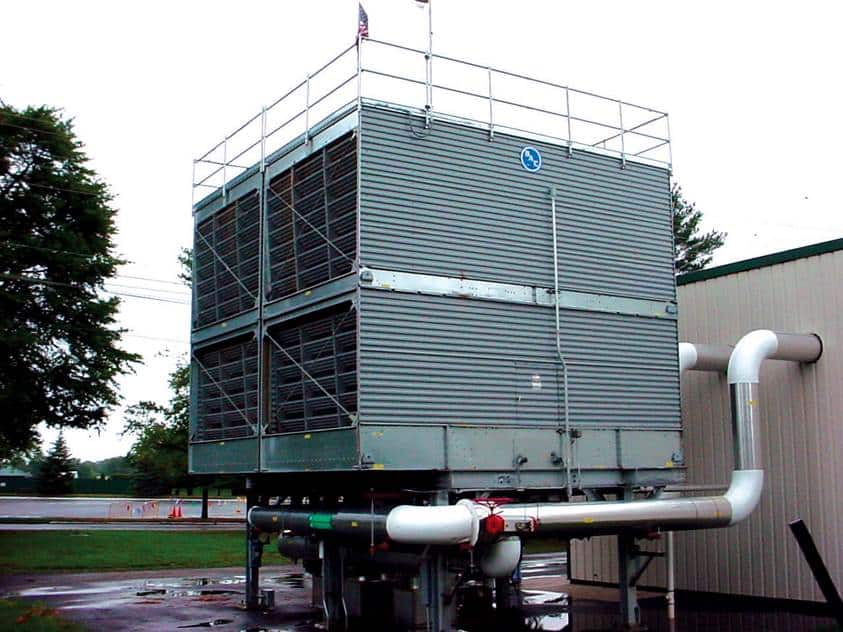 a man pressure washing outside of industrial hvac system