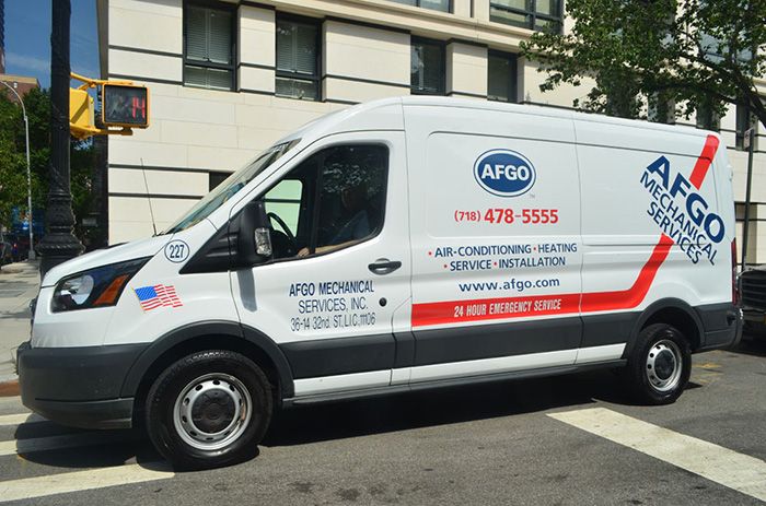 a man pressure washing outside of industrial hvac system